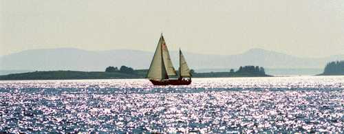 SAILBOAT AGAINST THE HILLS